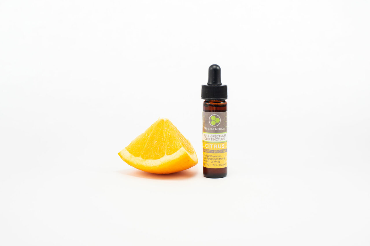 Premium Citrus Terpene - Full-Spectrum CBD Tincture - 300mg. Image of 7mL bottle and an 1/8 slice of a fresh orange.